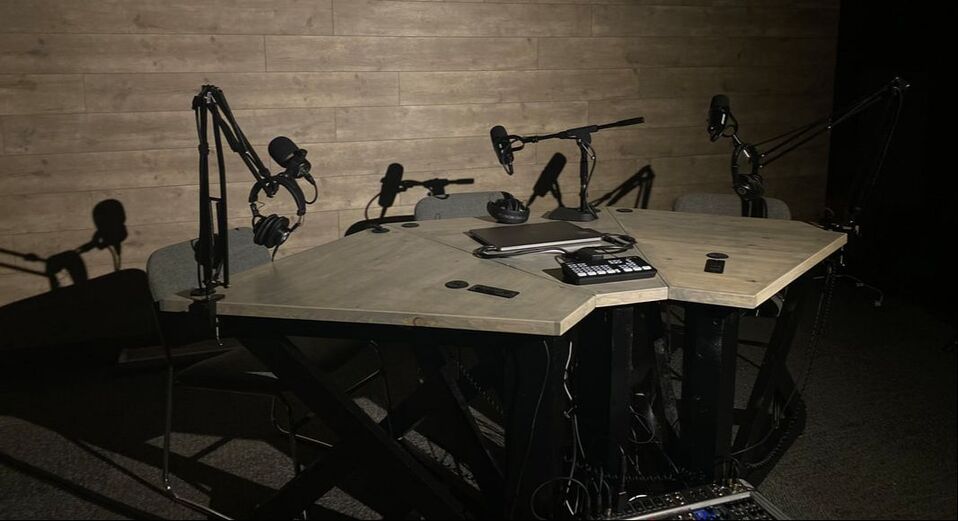 3 person modular podcast table setup with mics and mixer